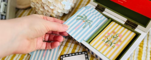 Hand holding striped playing cards from anthropologie