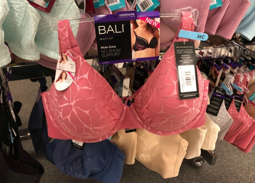 woman holding up a pink bra