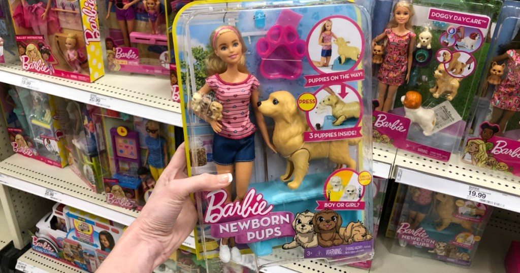 hand holding the Barbie with newborn pups set
