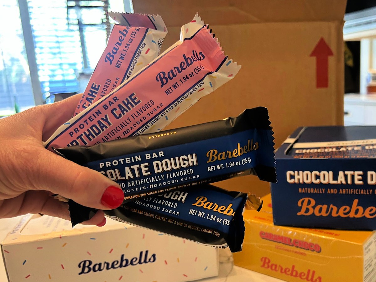 A person holding a few Barebells protein bars