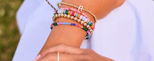 Woman wearing bauble bar stacked bracelets