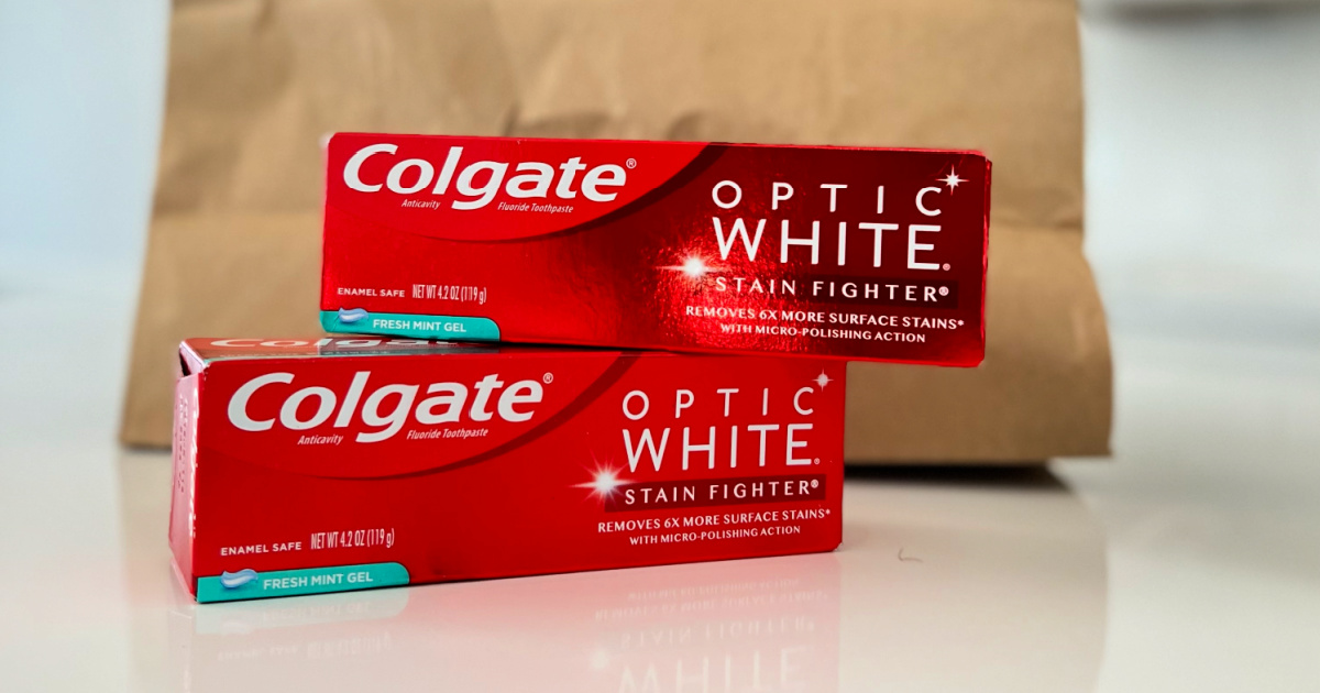 Two boxes of Colgate optic white toothpaste on kitchen counter