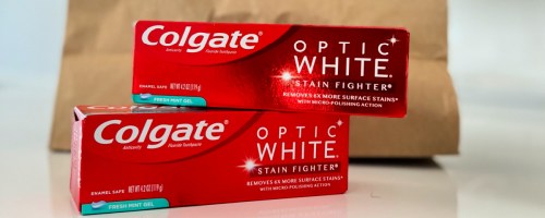 Two boxes of Colgate optic white toothpaste on kitchen counter