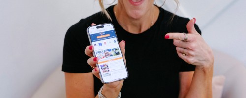Holding iPhone in hand and pointing with the other hand