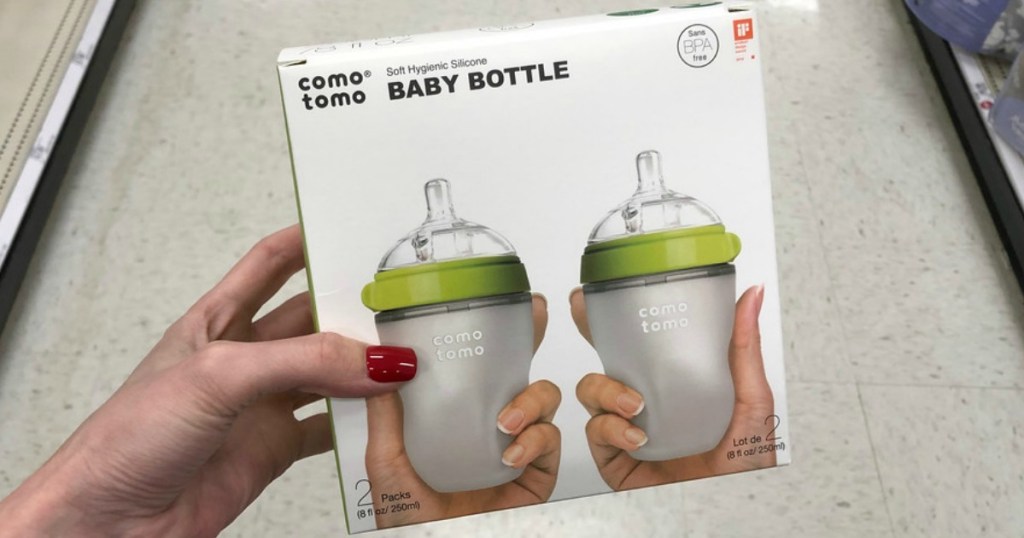 woman holding up a two pack box of baby bottles