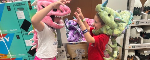 Kids in plush dinosaur costumes