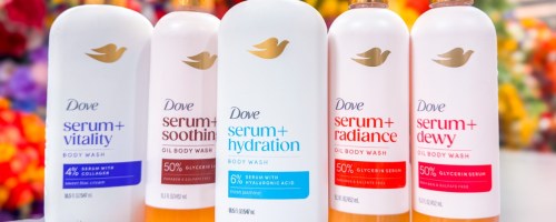 bottles of dove serum body wash lined up on counter in store