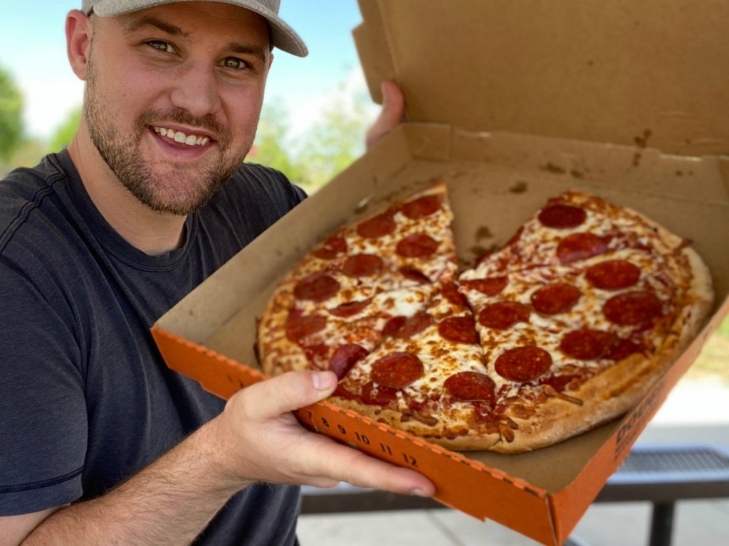 man holding pizza in box