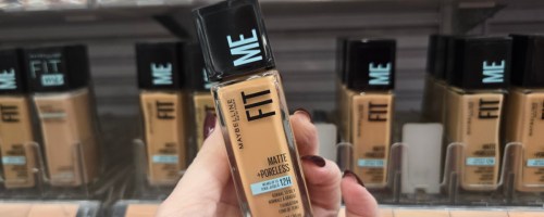 Woman holding bottle of Maybelline foundation