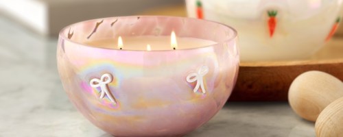 member's mark icon bow candle in pink on table with wooden egg decoration