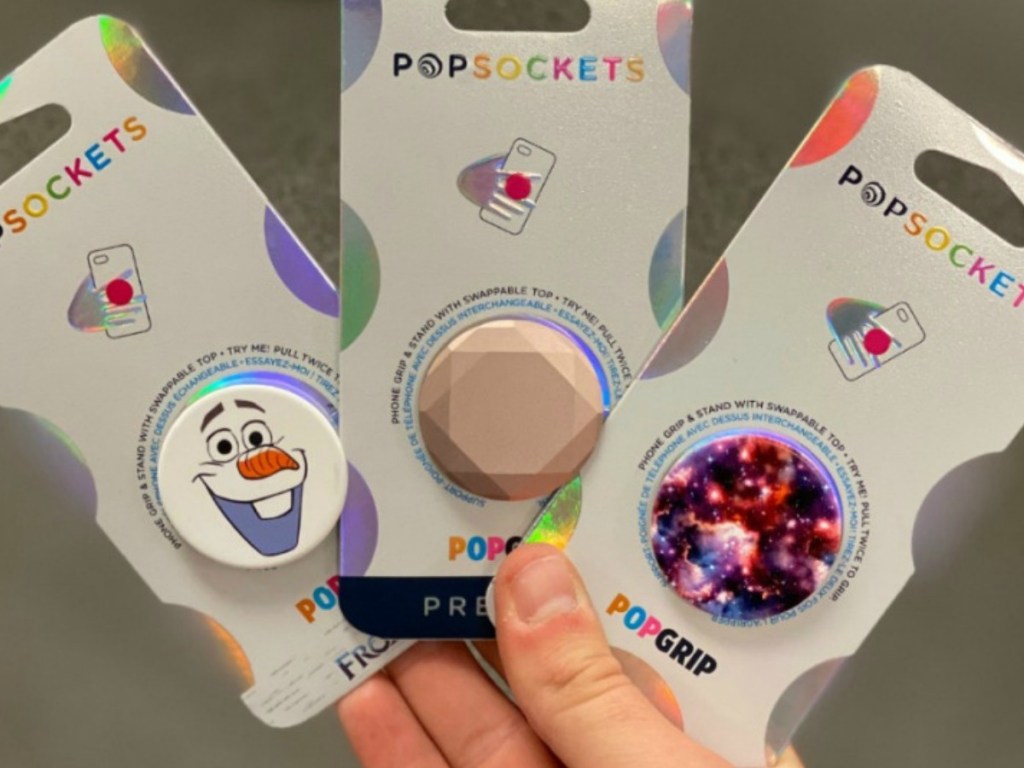 holding 3 PopSockets Popgrip packs