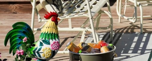 Rooster and white bench outside on patio