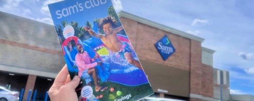 hand holding sams club instant savings booklet