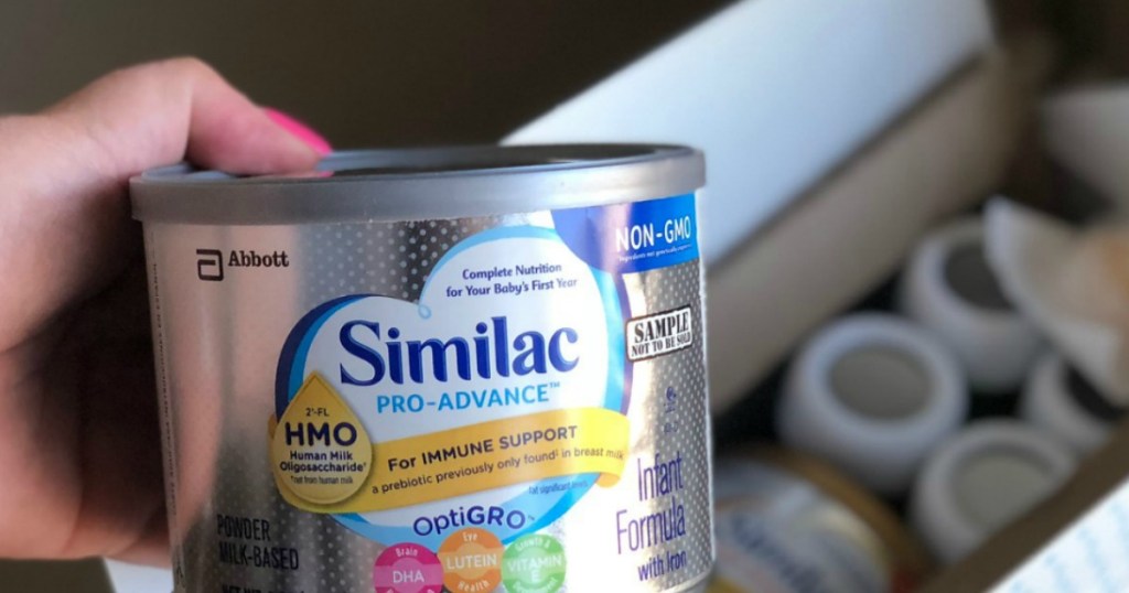 hand holding container of Similac formula