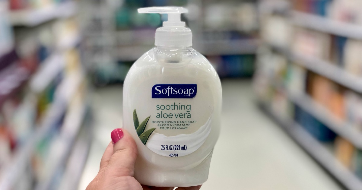 hand holding softsoap with blurry background