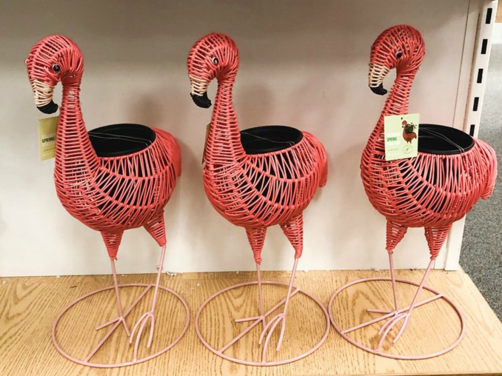 three flamingo wicker planters on store shelf