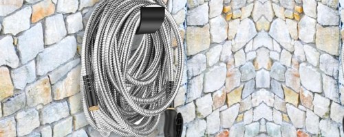 Stainless steel hose hanging on stone wall