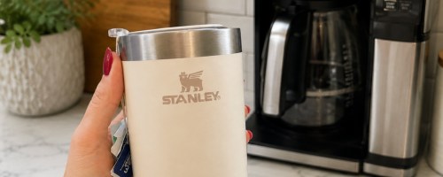 And holding cream colors, Stanley cup in front of coffee maker
