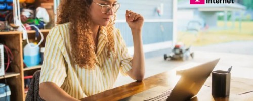 woman sitting at desk with laptop and t-mobile logo in corner