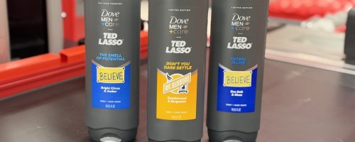 three bottles of dove+men body wash with ted lasso theme sitting on target checkout belt