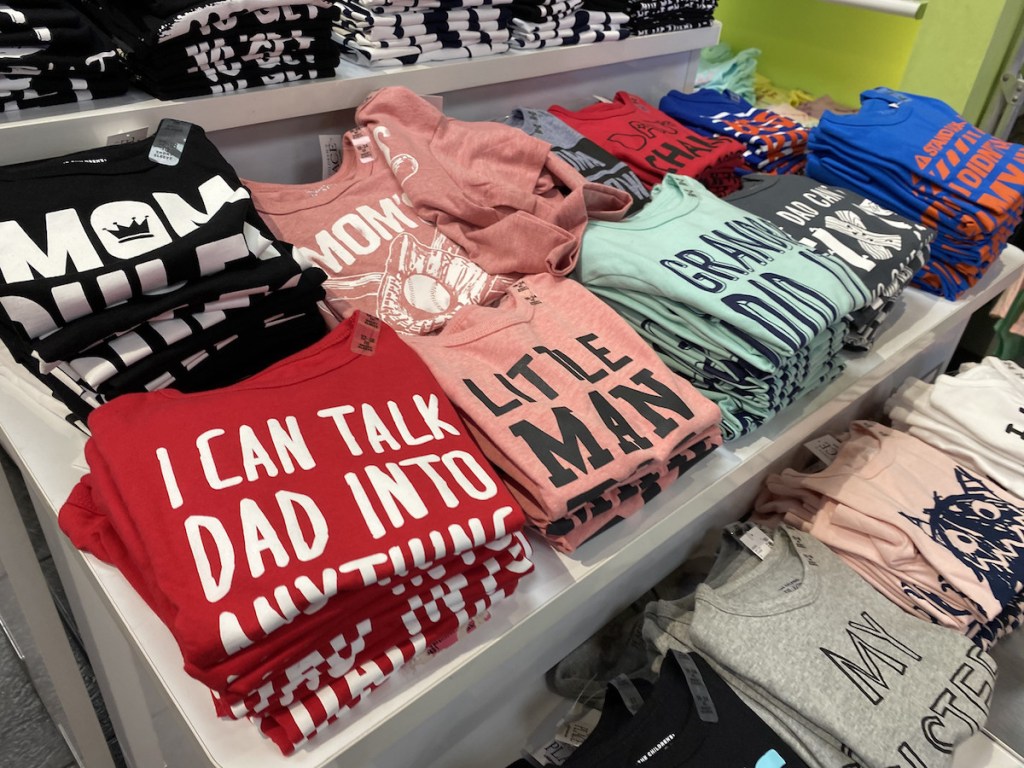 T-shirts laid on display table at store
