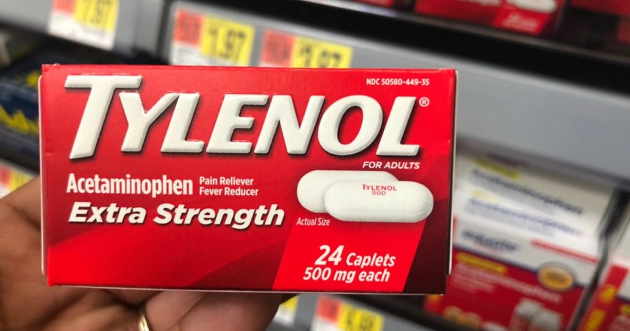 holding a box of Tylenol