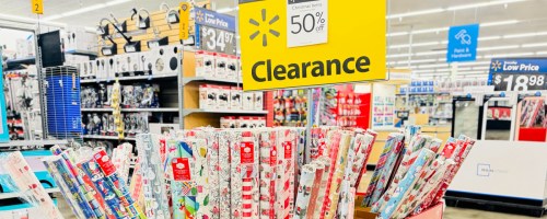 walmart christmas clearance sign next to wrapping paper display