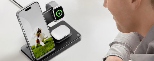 Man, looking at phone screen with phone, charging and watch an AirPods charging