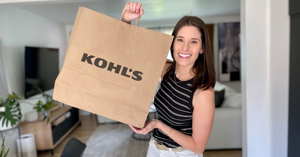 woman holding up a big kohl's bag