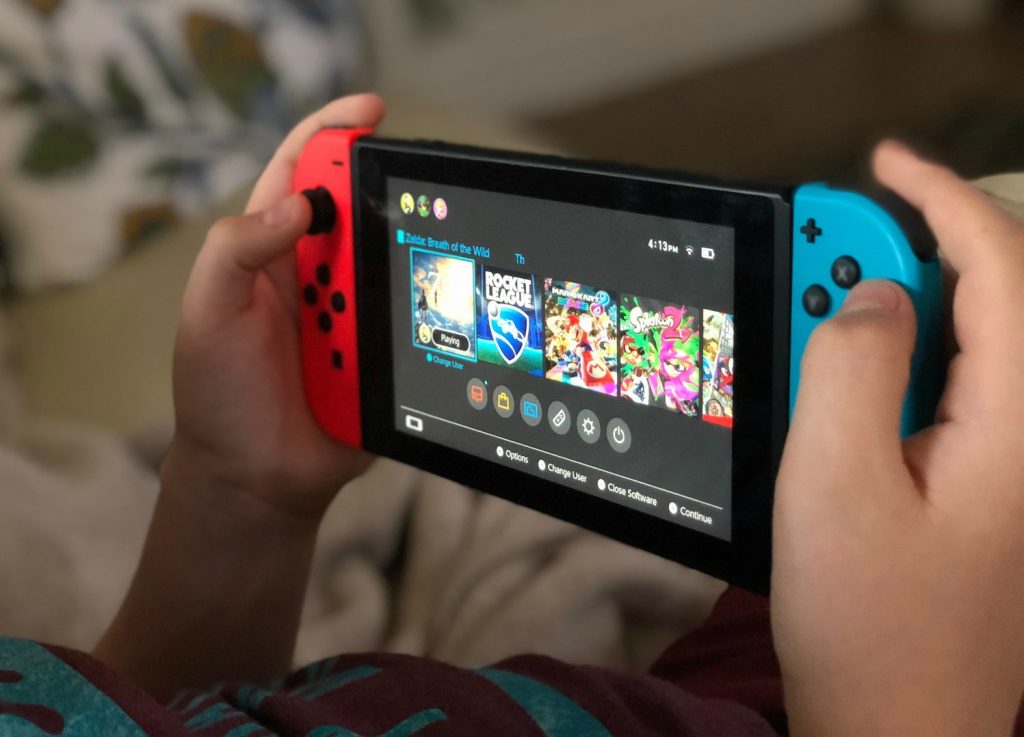 boy playing with a Nintendo Switch console