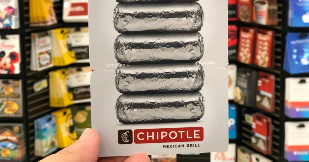 chipotle gift card being held in front of gift card display in store