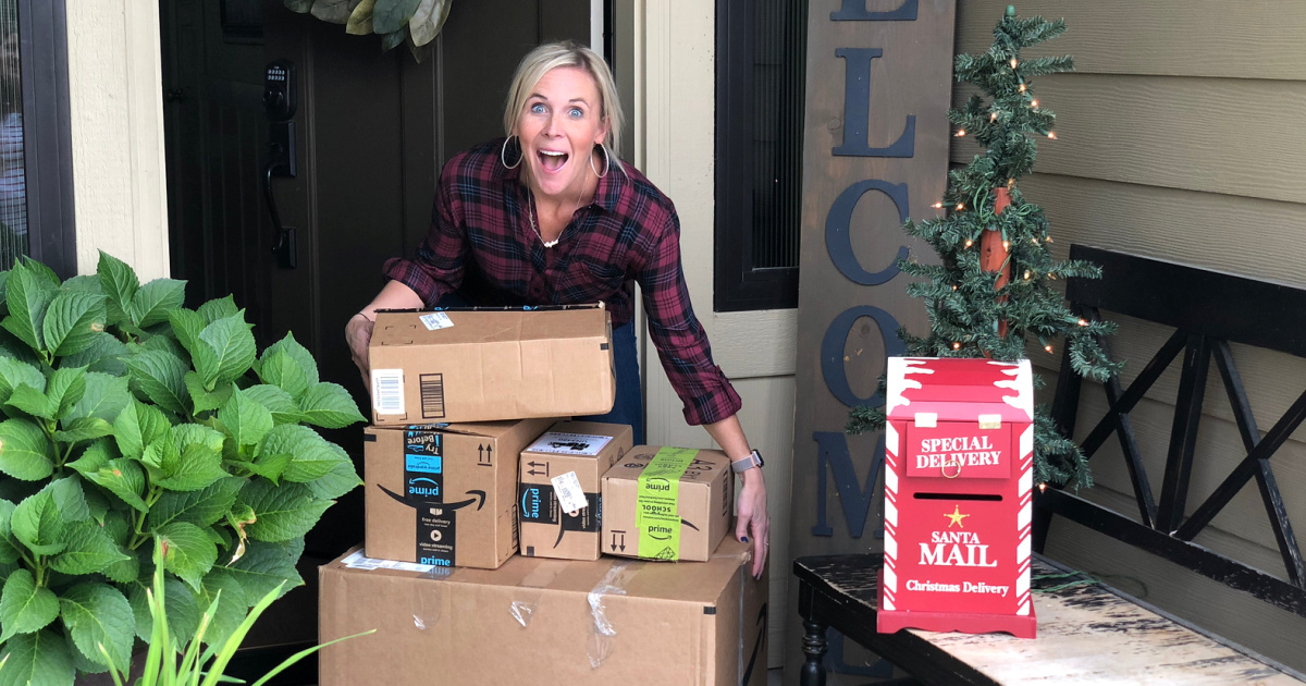 woman on front porch with amazon boxes