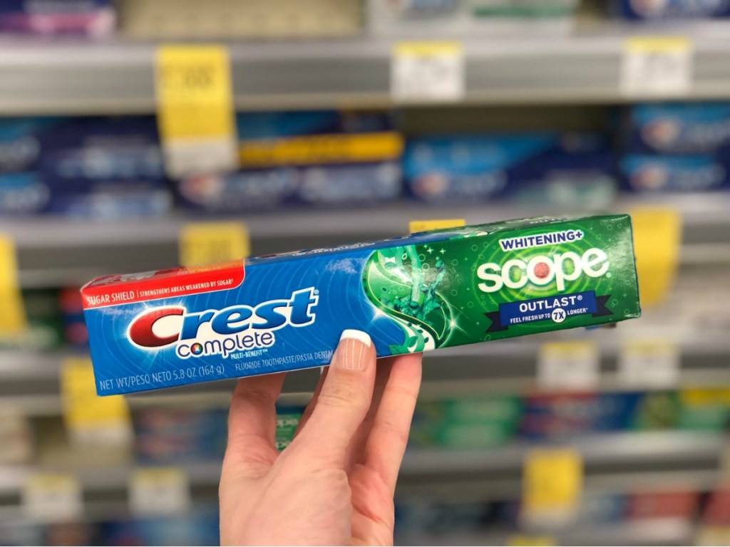 hand holding crest complete toothpaste in store