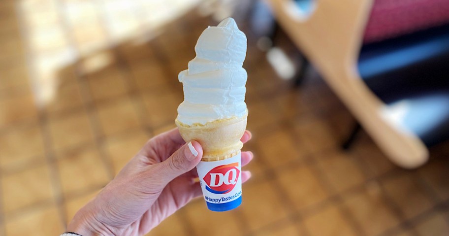 hand holding a vanilla dairy queen ice cream cone