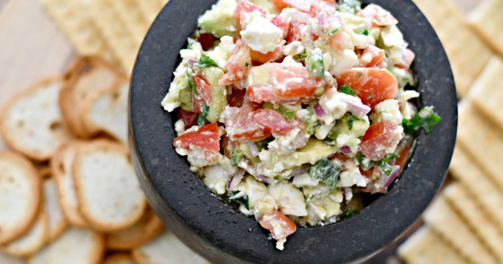 a bowl of avocado feta salsa dip which is perfect for a game day party