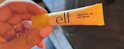 Hand holding elf squeeze me lip balm