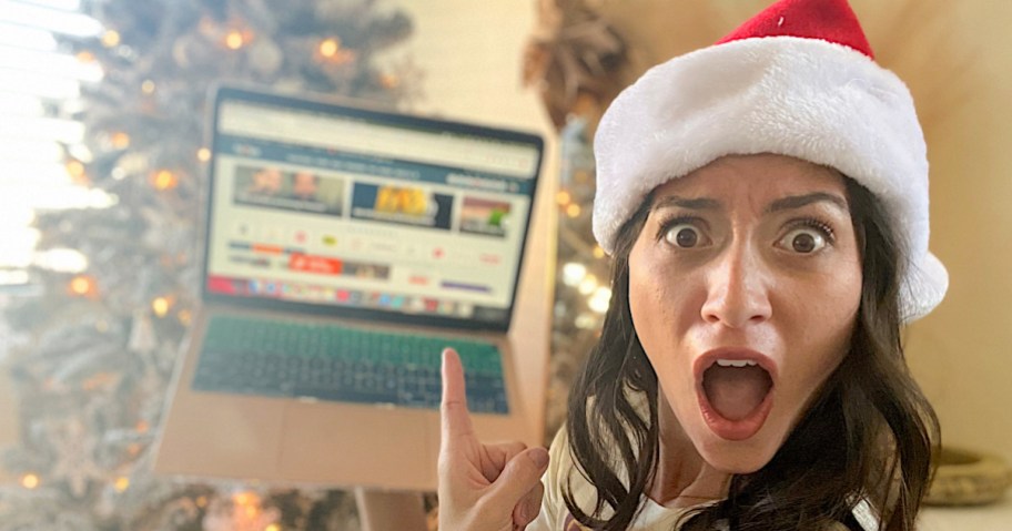 woman excited holding laptop