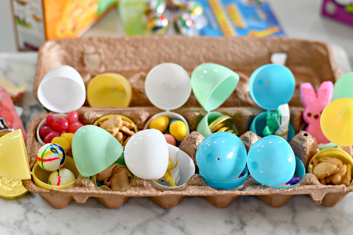 easter eggs filled with candy, stickers, and toys, in an egg carton