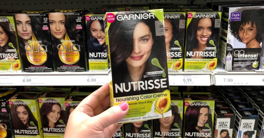 hand holding up a box of garnier hair color