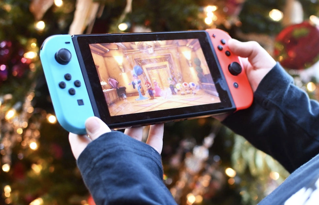 holding a nintendo switch