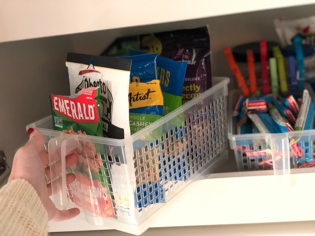 pulling out pantry organizer basket with nuts inside
