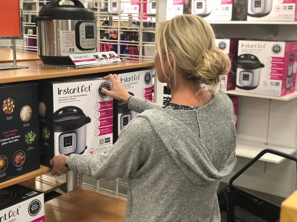 Collin looking at 7 in 1 Instant Pot on Kohl's shelf