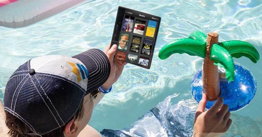 person reading kindle in pool