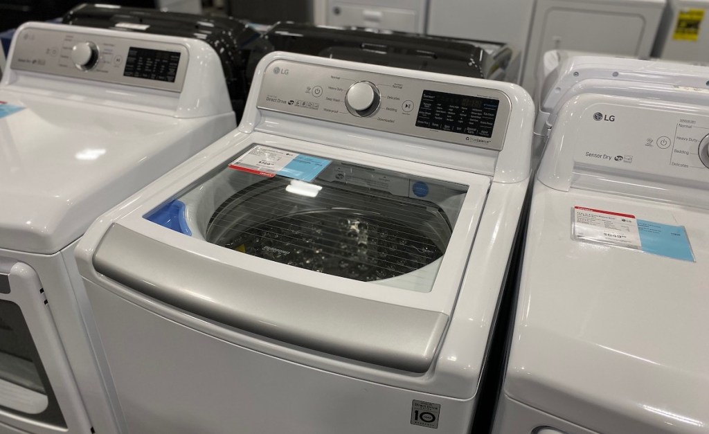 white top load washing machine with price tag in store