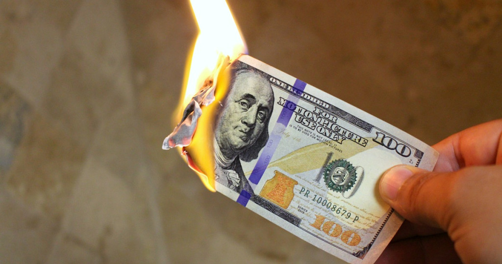 $100 bill on fire