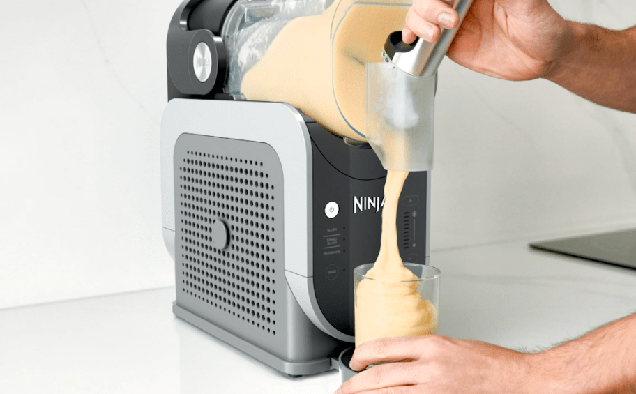 person pouring slushi out of machine 