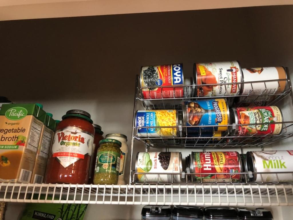 pantry organized with stackable mental organizer for canned goods