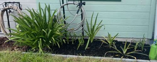 Stainless Steel Water Hose against a house