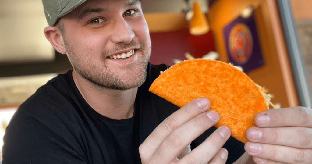Man holding a Doritos Locos Taco at Taco Bell