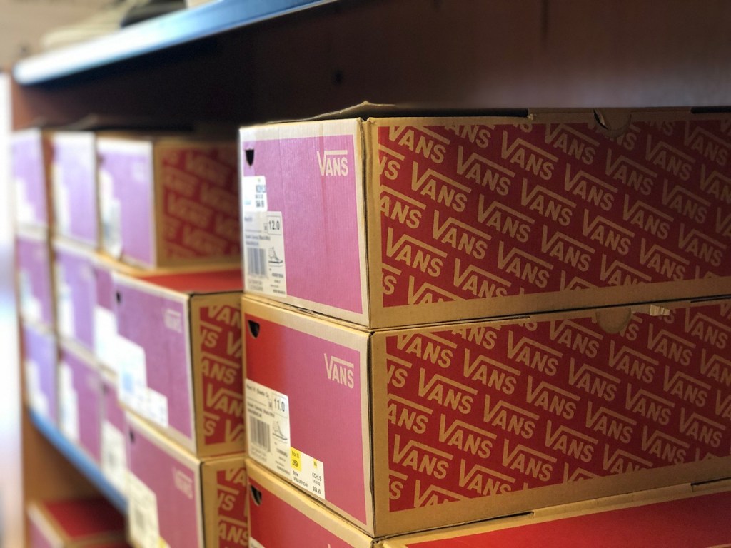 Vans shoe boxes stacked on shelf 